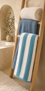 Willow & Fern towels styled on a wooden ladder in a stone bathroom