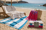 Willow & Fern striped beach towels on a sunlit beach